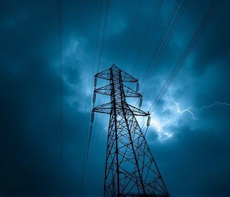 Electric power lines against a storm cloud sky